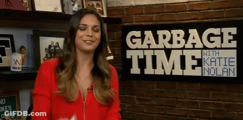 Woman Smiling In Front Of Garbage Time Sign GIF