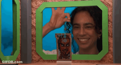 Woman Smiling In Front Of Green Frame With Man Picture GIF