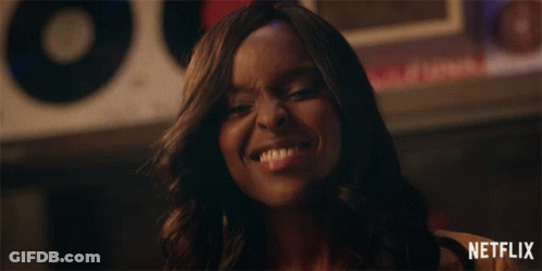 Woman Smiling In Front Of Netflix Sign GIF