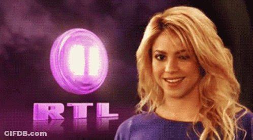Woman Smiling In Front Of Purple RTL Logo GIF