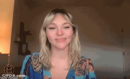 Woman Smiling In Front Of Taylor Hickson Screen GIF
