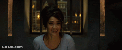 Woman Smiling In Front Of Window With City Background GIF