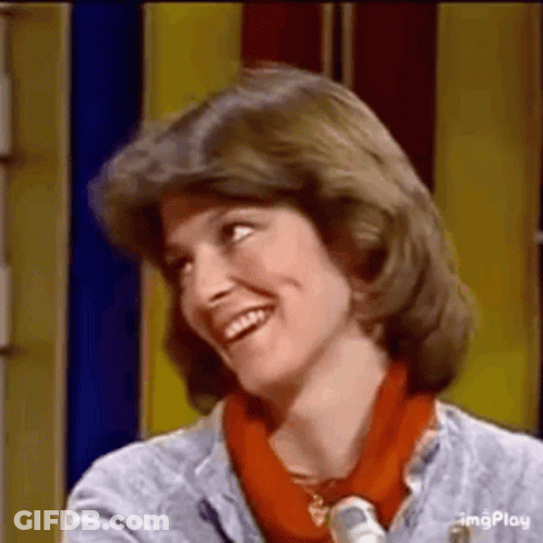 Woman Smiling In Front Of Yellow Wall GIF
