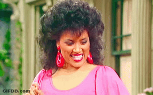 Woman Smiling In Pink Top And Red Earrings GIF