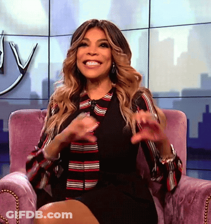 Woman Smiling In Purple Chair Legs Crossed GIF