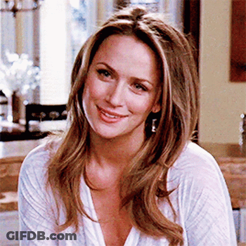 Woman Smiling In White Shirt And Earrings GIF
