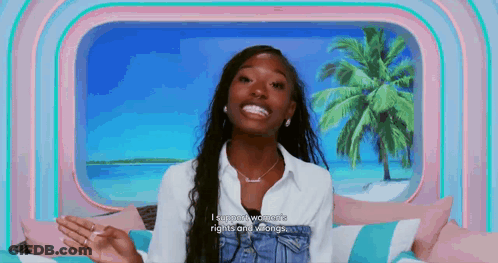 Woman Smiling On Bed By Window With Palm Tree GIF