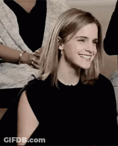 Woman Smiling On Couch With Others GIF