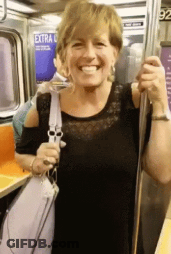 Woman Smiling On Subway With Extra Sign GIF