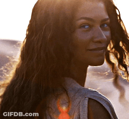 Woman Smiling Over Shoulder With Long Hair GIF
