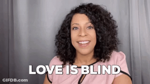 Woman Smiling Saying Love Is Blind In Pink Shirt GIF