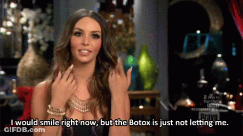 Woman Smiling Talking About Botox On Red Couch GIF