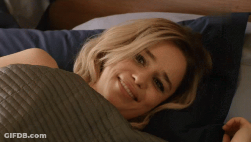Woman Smiling Under Quilt GIF