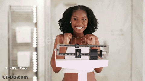 Woman Smiling While Standing On Scale GIF