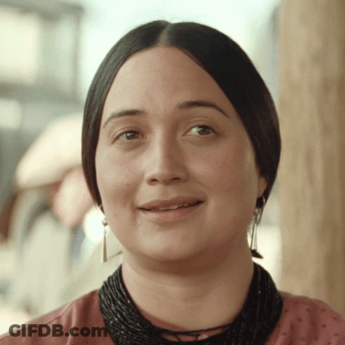 Woman Smiling With Black Necklace And Earrings GIF