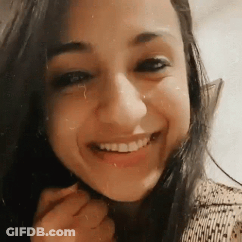Woman Smiling With Hand On Chin GIF