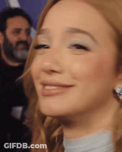 Woman Smiling With Man In Background GIF