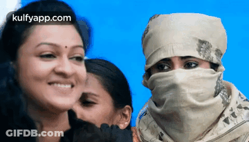 Woman Smiling With Scarf Next To Two Women GIF