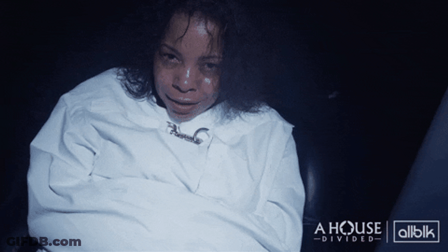 Woman Smirking In Straight Jacket GIF