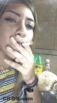 Woman Smoking Cigarette At Sink GIF