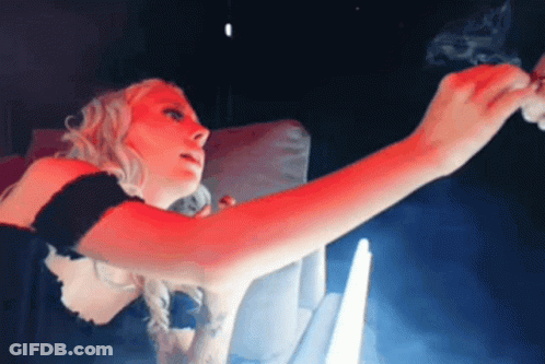 Woman Smoking Cigarette In Dark Room With Red Light GIF