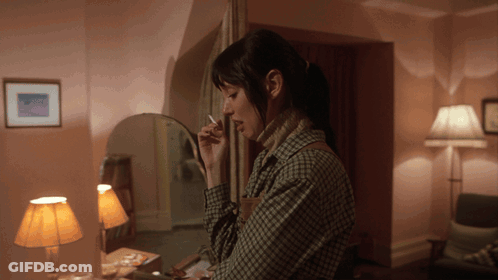 Woman Smoking Cigarette In Mirror GIF