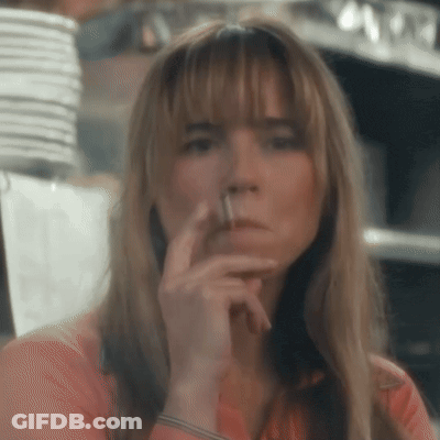 Woman Smoking Cigarette Looking At Camera GIF