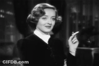 Woman Smoking Cigarette Smiling Black And White GIF