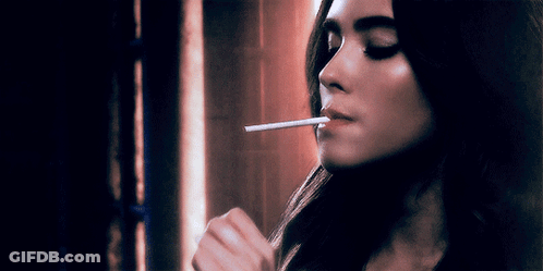 Woman Smoking Cigarette With Eyes Closed GIF