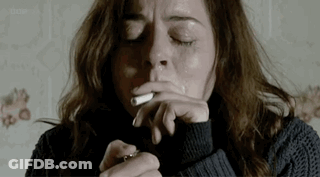 Woman Smoking Cigarette With Eyes Closed GIF