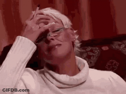 Woman Smoking On Couch Rubbing Forehead GIF