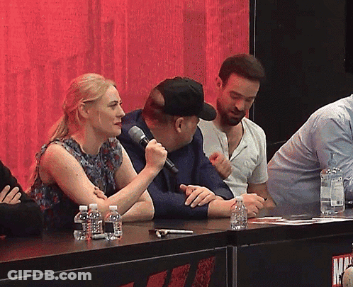 Woman Speaking Into Microphone With Water Bottles GIF