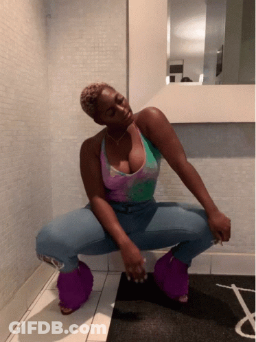 Woman Squatting In Front Of Mirror In Purple Fuzzy Slippers GIF
