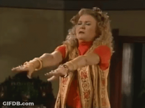 Woman Standing Arms Outstretched Making Funny Face GIF