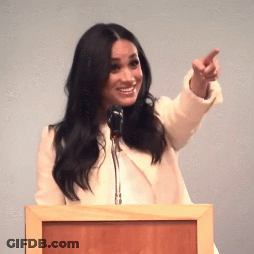 Woman Standing At Podium Pointing GIF
