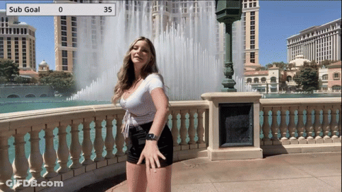 Woman Standing At Water Fountain With Sub Goal 35 GIF