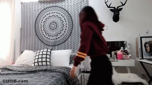 Woman Standing Before Bed With Mandala Tapestry GIF