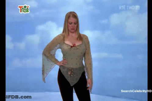 Woman Standing Before RTE Two Screen GIF
