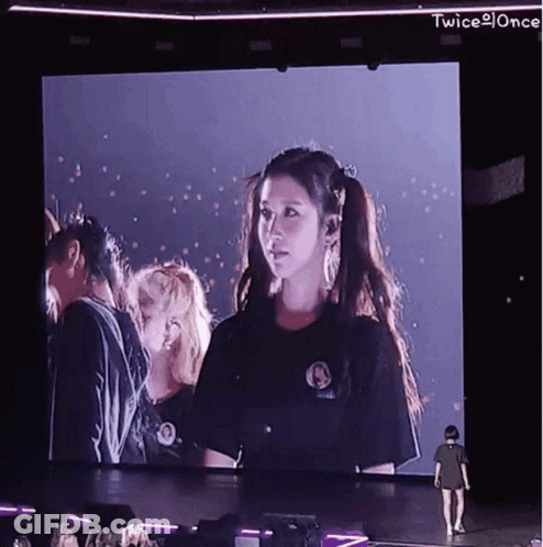 Woman Standing Before Twice Screen GIF