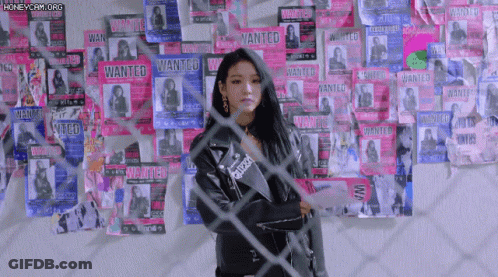 Woman Standing Before Wanted Posters GIF