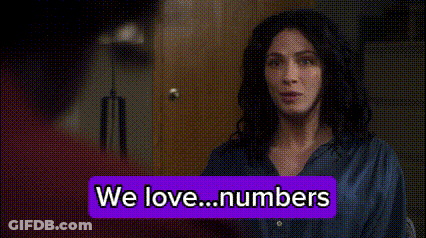 Woman Standing Before We Love Numbers Sign GIF