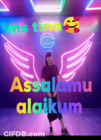 Woman Standing By Assalamu Alaikum Neon Sign GIF