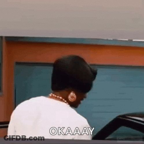 Woman Standing By Garage Door Saying Okay GIF