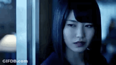 Woman Standing By Window In Dark Room GIF
