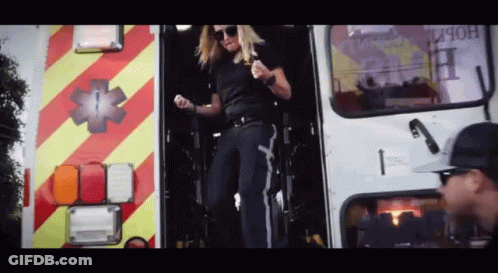 Woman Standing In Ambulance Doorway GIF