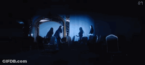 Woman Standing In Dark Room GIF