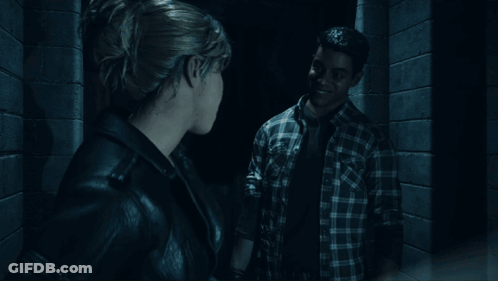 Woman Standing In Dark Room Looking Out Doorway GIF