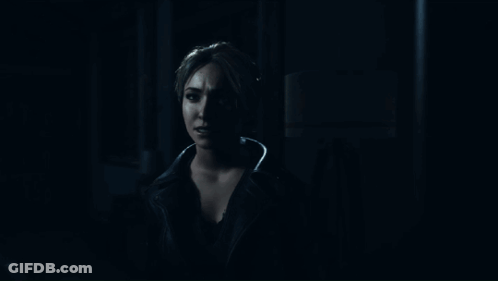 Woman Standing In Dark Room Looking Out Doorway GIF
