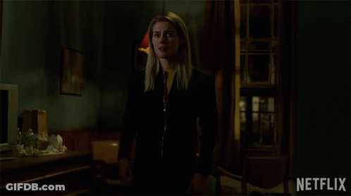 Woman Standing In Dark Room Netflix Logo GIF
