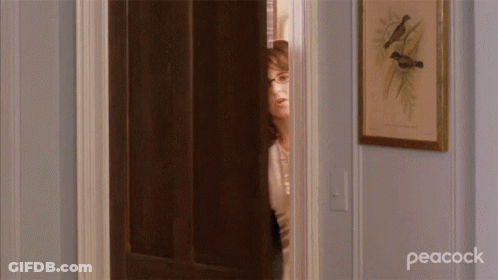 Woman Standing In Doorway With Peacock GIF